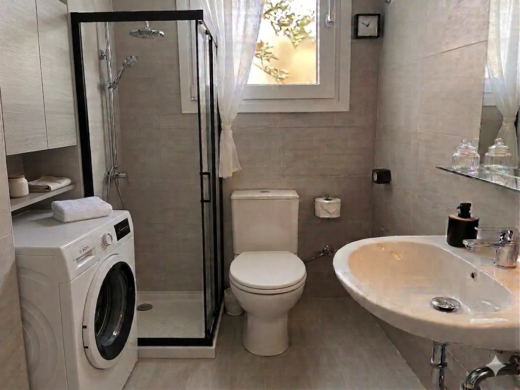 Bathroom with shower and washer